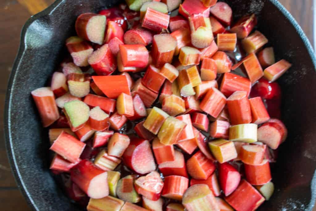 Rhubarb layer in cast iron skillet before the oat crisp topping has been added