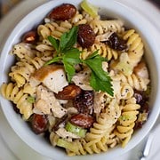 Chicken Salad with rotini pasta, dried cherries, whole almonds in a poppy seed dressing in a ramekin