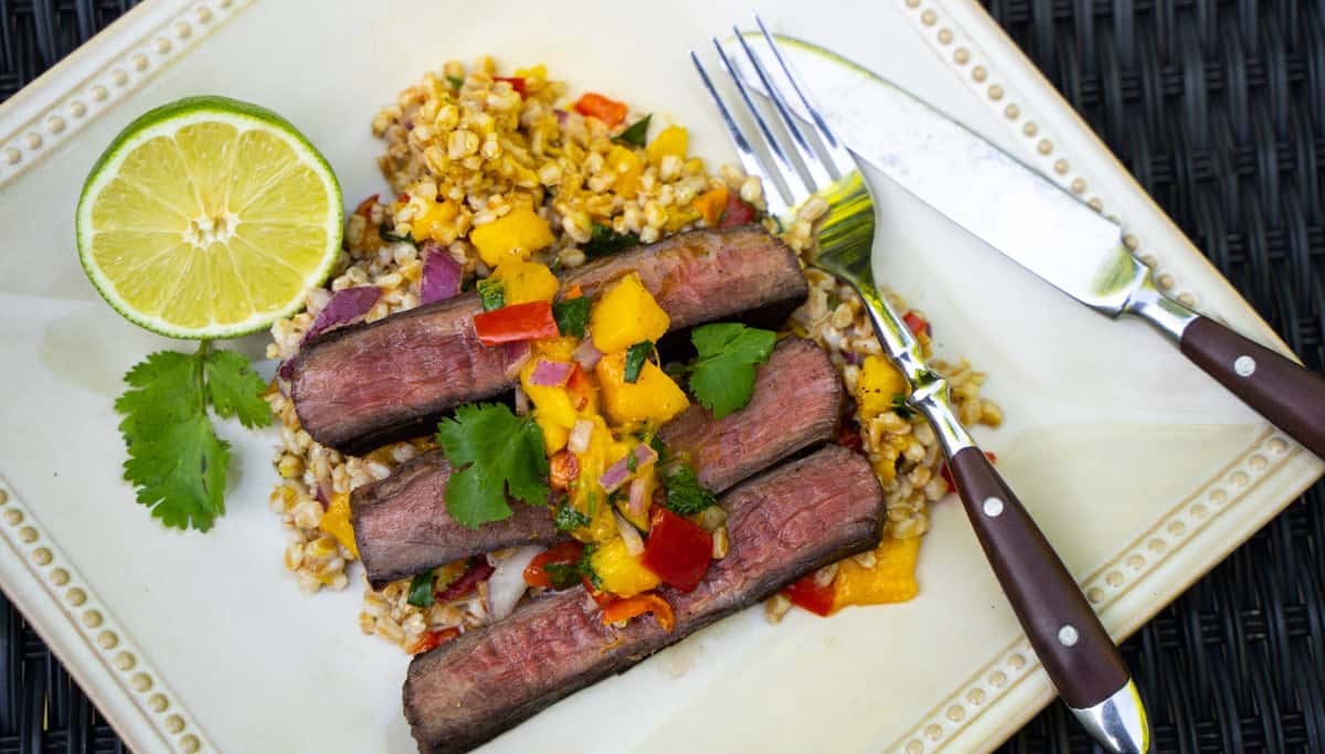Flank Steak for Two with Mango Salsa and Farro on a plate