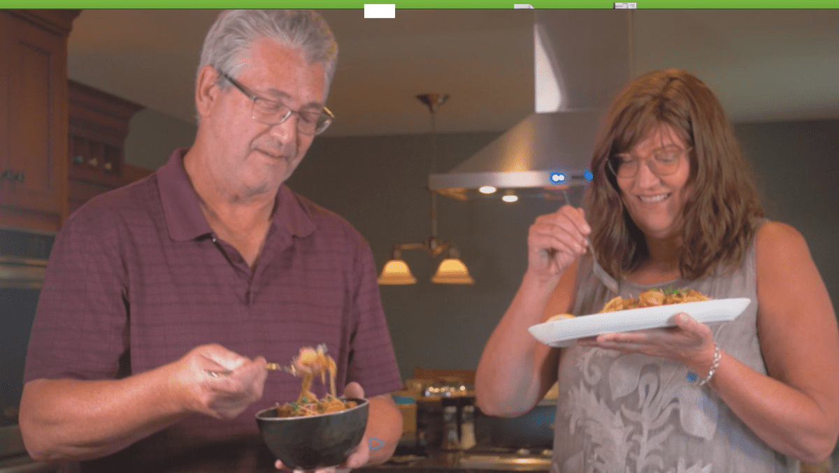 Easy shrimp pasta recipe being made and shared by a women and man in a home kitchen