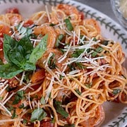 Easy Shrimp Pasta Recipe (Weeknight Dinner For Two)A white wine and diced tomato sauce covers a Garlic sautéed Shrimp Pasta garnished with fresh herbs and parmesan