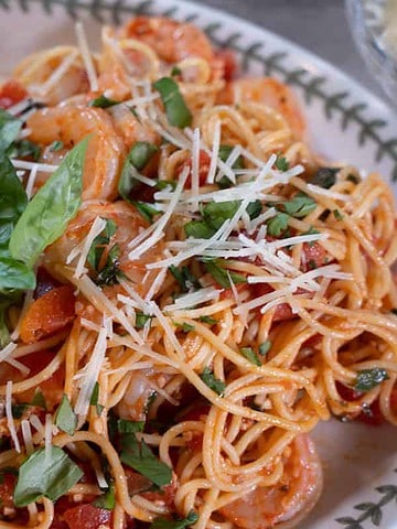 Easy Shrimp Pasta Recipe (Weeknight Dinner For Two)A white wine and diced tomato sauce covers a Garlic sautéed Shrimp Pasta garnished with fresh herbs and parmesan
