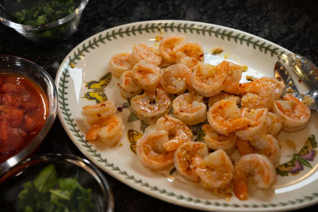 shrimp sauteed in garlic, white-wing and olive oil on a white serving platter