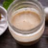 our favorite shallot vinaigrette perfect for two in a mason jar sitting on a wood table