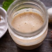 our favorite shallot vinaigrette perfect for two in a mason jar sitting on a wood table