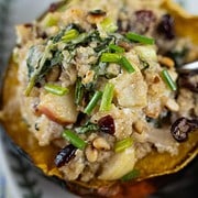 Quinoa stuffed acorn squash with leeks, apples, goat cheese, pine nuts. Garnished with chives