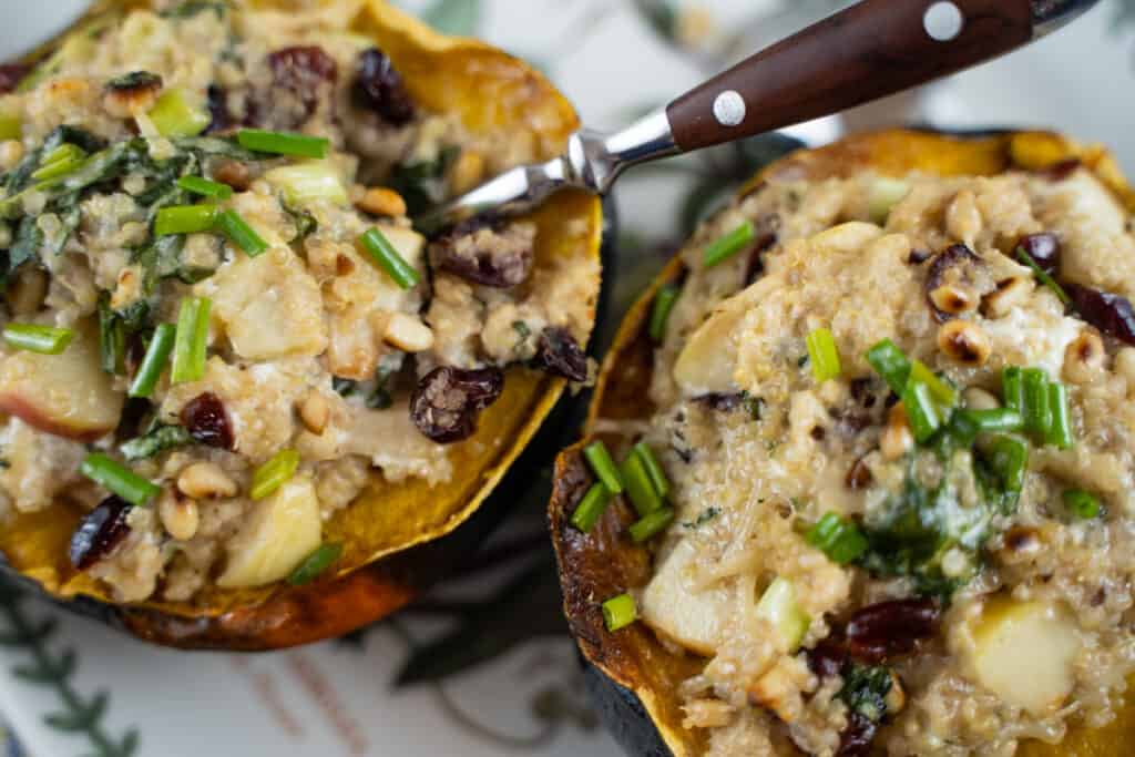 Quinoa stuffed acorn squash with leeks, apples, goat cheese, pine nuts. Garnished with chives