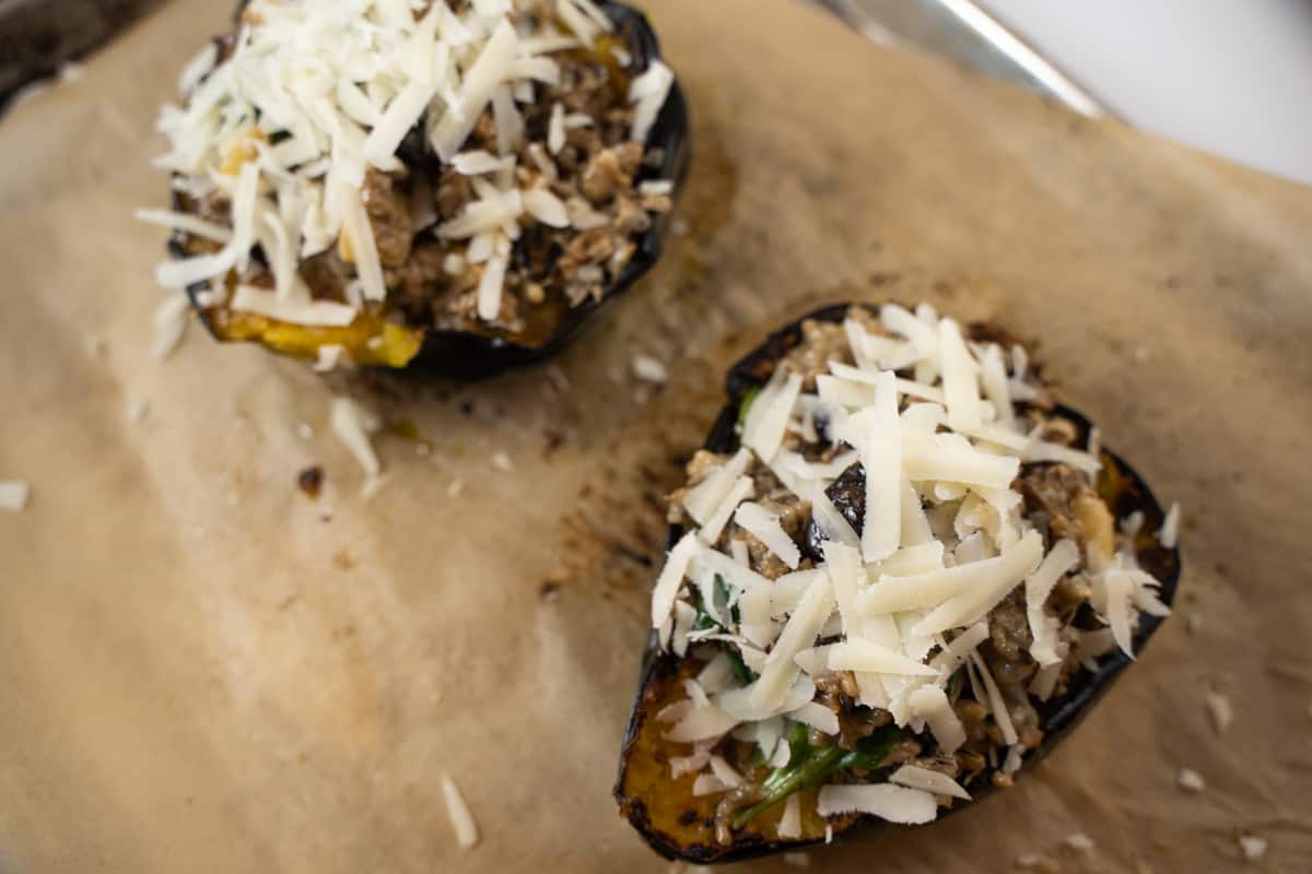 Sausage stuffed acorn squash for two ready to be baked in the oven.