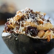 stuffed acorn squash with sausage, dried cranberries, apples, onion and a sour dough bread crumb topping