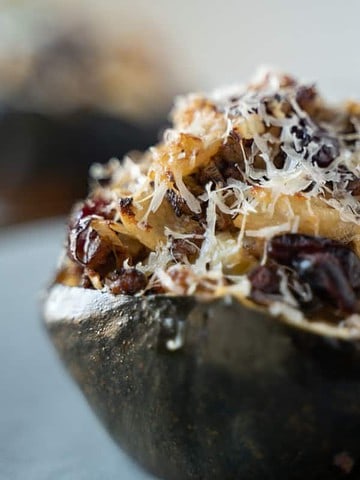 stuffed acorn squash with sausage, dried cranberries, apples, onion and a sour dough bread crumb topping
