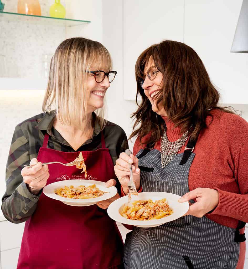 2 women eating prosciutto pasta