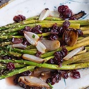 Asparagus For Two with roasted shallots and cranberry vinaigrette on a white serving platter
