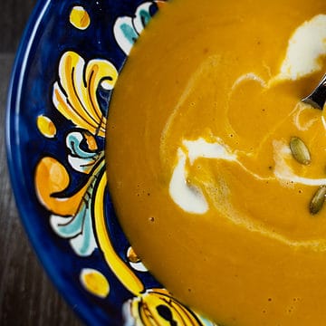 Butternut Squash Soup For Two in a Sicilian Soup Bowl garnished with cream and pepitas