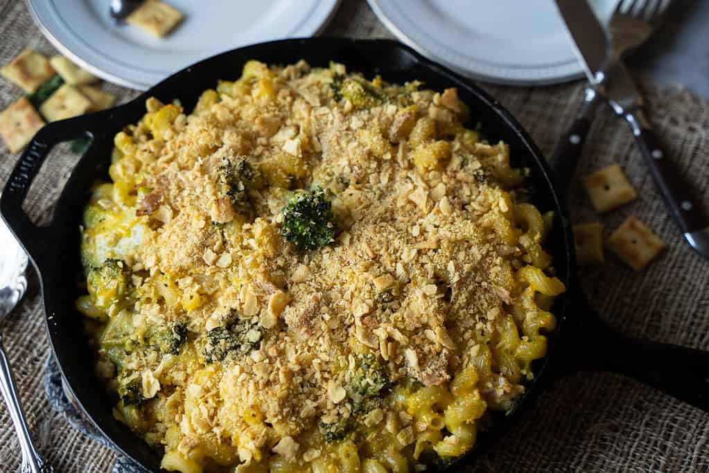 Chicken Broccoli Pasta Casserole For Two in a cast iron skillet with a white cheddar cheez-it topping