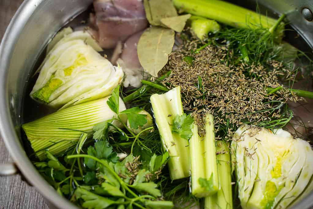 small batch homemade chicken stock ingredients in a stock pot