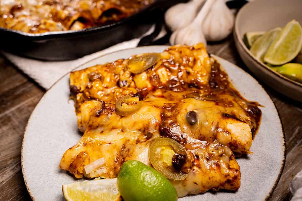Tex Mex Cheese Enchiladas for two in a cast iron skillet and served on a plate
