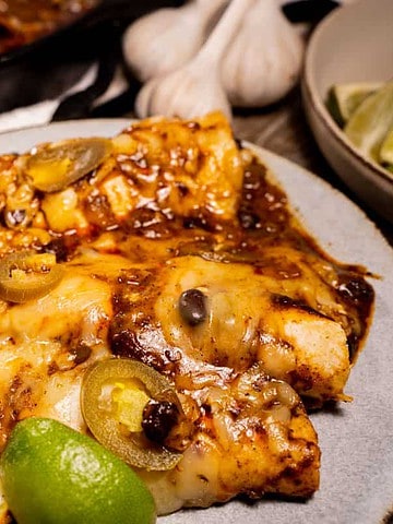 Tex Mex Cheese Enchiladas for two in a cast iron skillet and served on a plate
