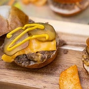 loose meat on a pretzel bun sitting on a cutting board
