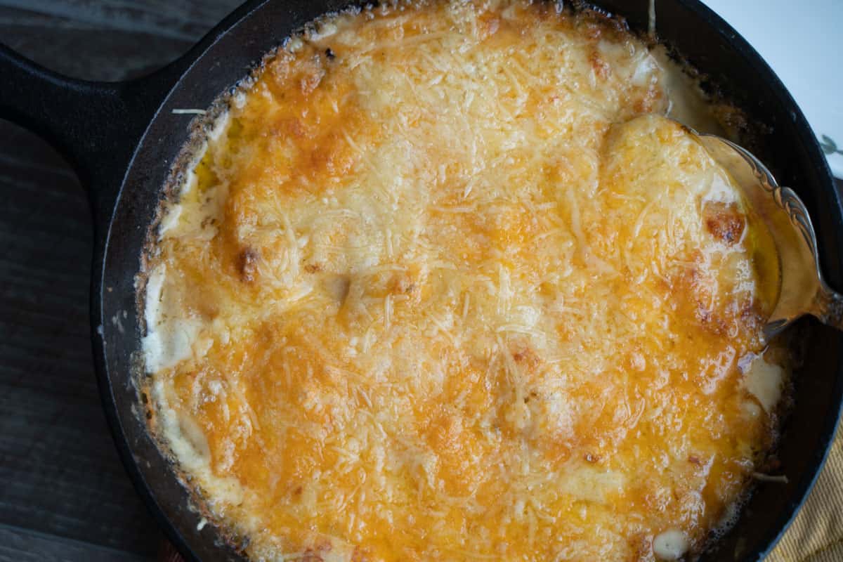 baked scalloped potatoes for two in a cast iron skillet