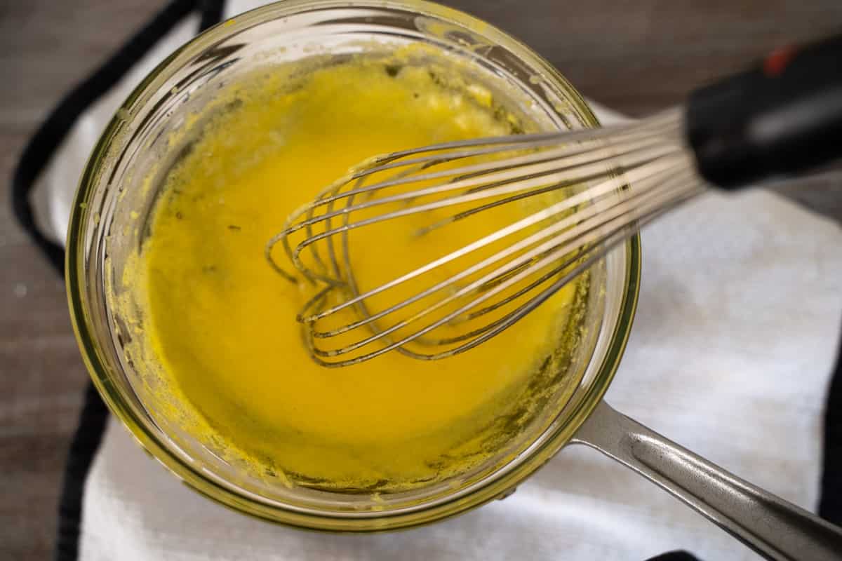 whisking foolproof hollandaise sauce over indirect heat