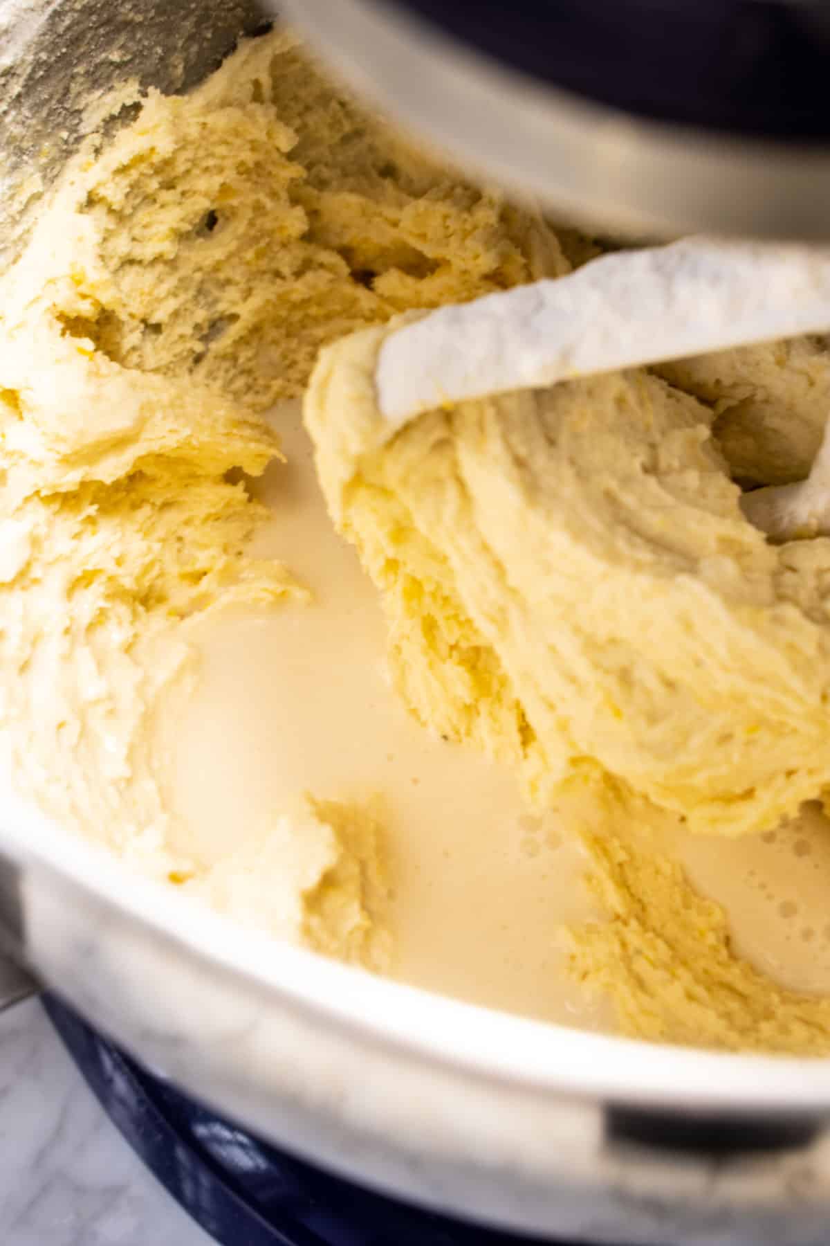 buttermilk mixture added to cake batter in stand mixing bowl