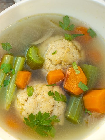 Matzo ball soup recipe in a white bowl