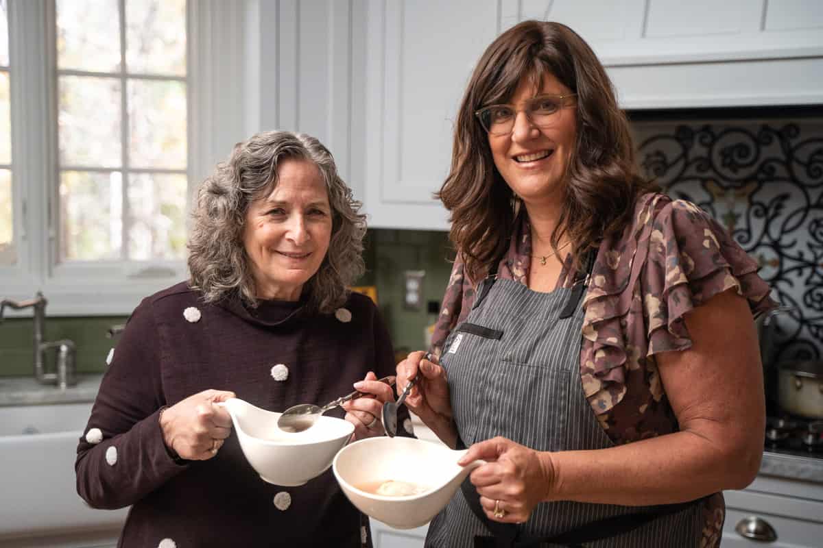 Two women in the kitchen tasting Matzo Ball Soup