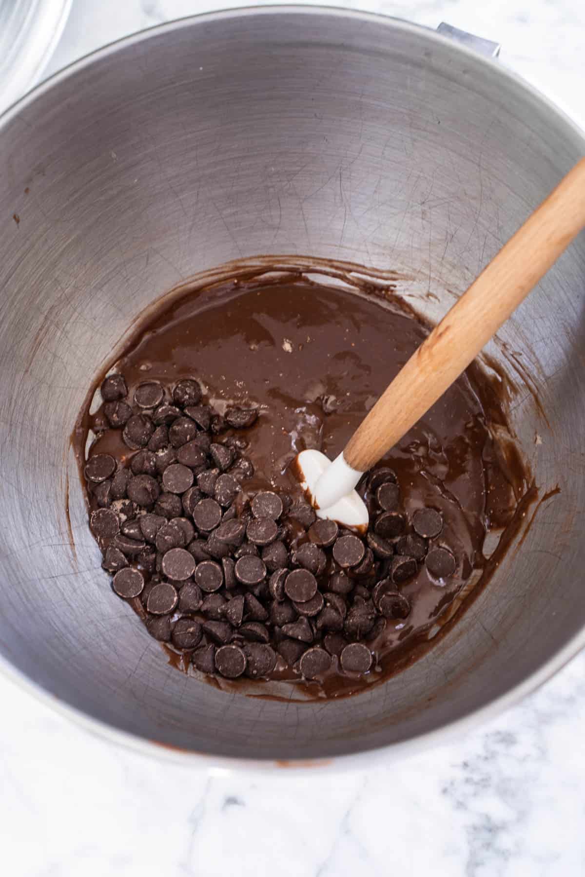 folding chocolate chips into chocolate bundt cake batter with rubber spatula