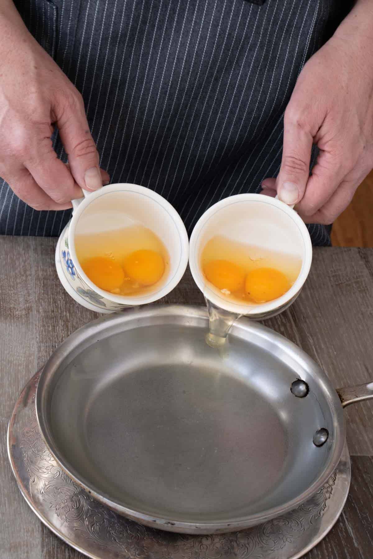 adding eggs to boiling water using teacups