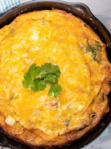 Mexican Frittata in a cast iron pan with cilantro garnish