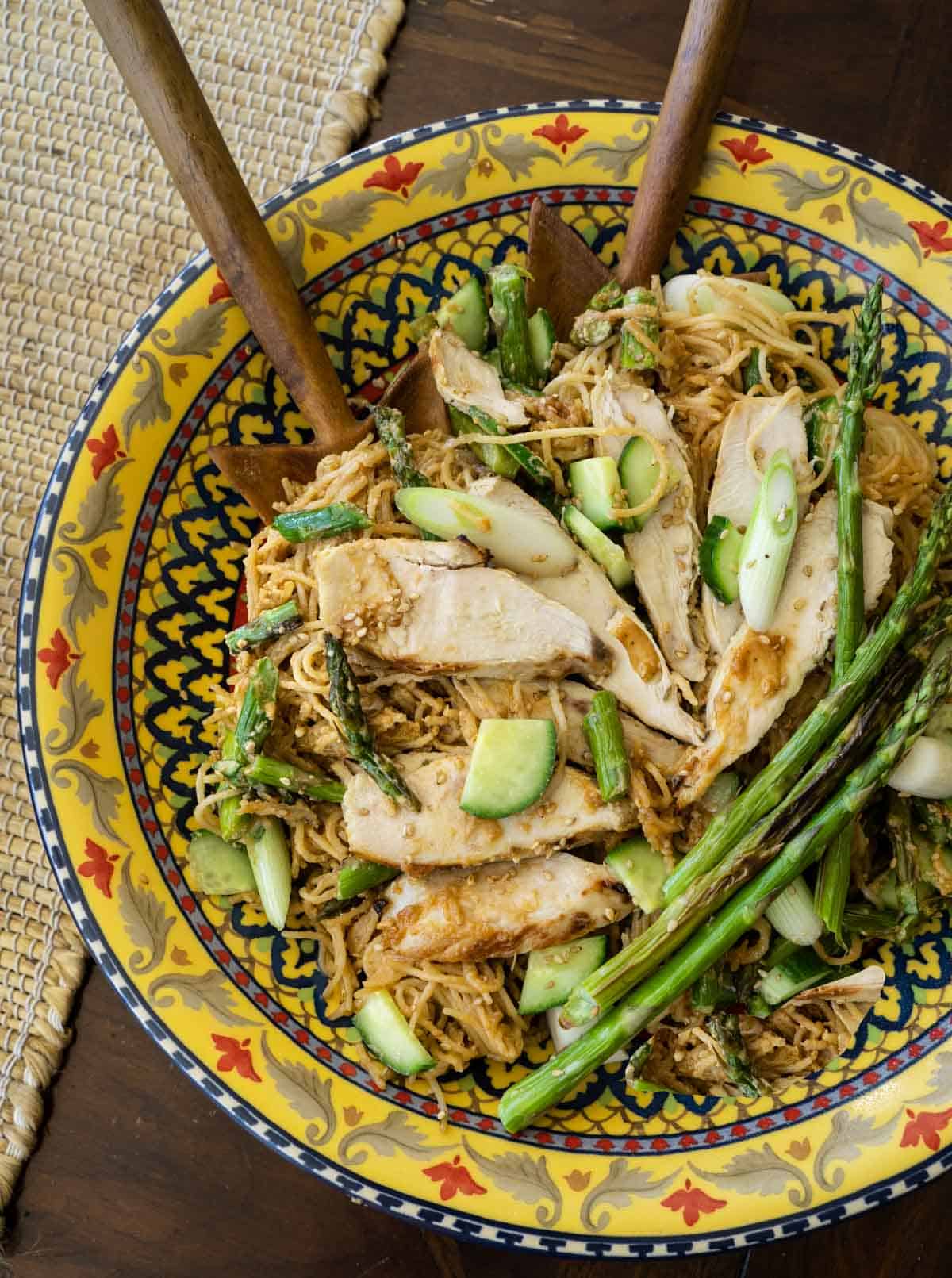 Sesame Noodles topped with chicken, asparagus, cucumbers and green onions in a Sicilian pasta bowl