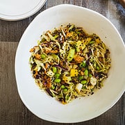 Ramen noodle salad in a white bowl on wooden table