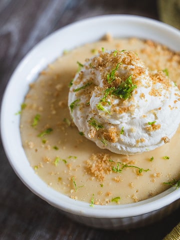 Key Lime Pie filling in a ramekin sprinkled with graham cracker topping and whipped cream