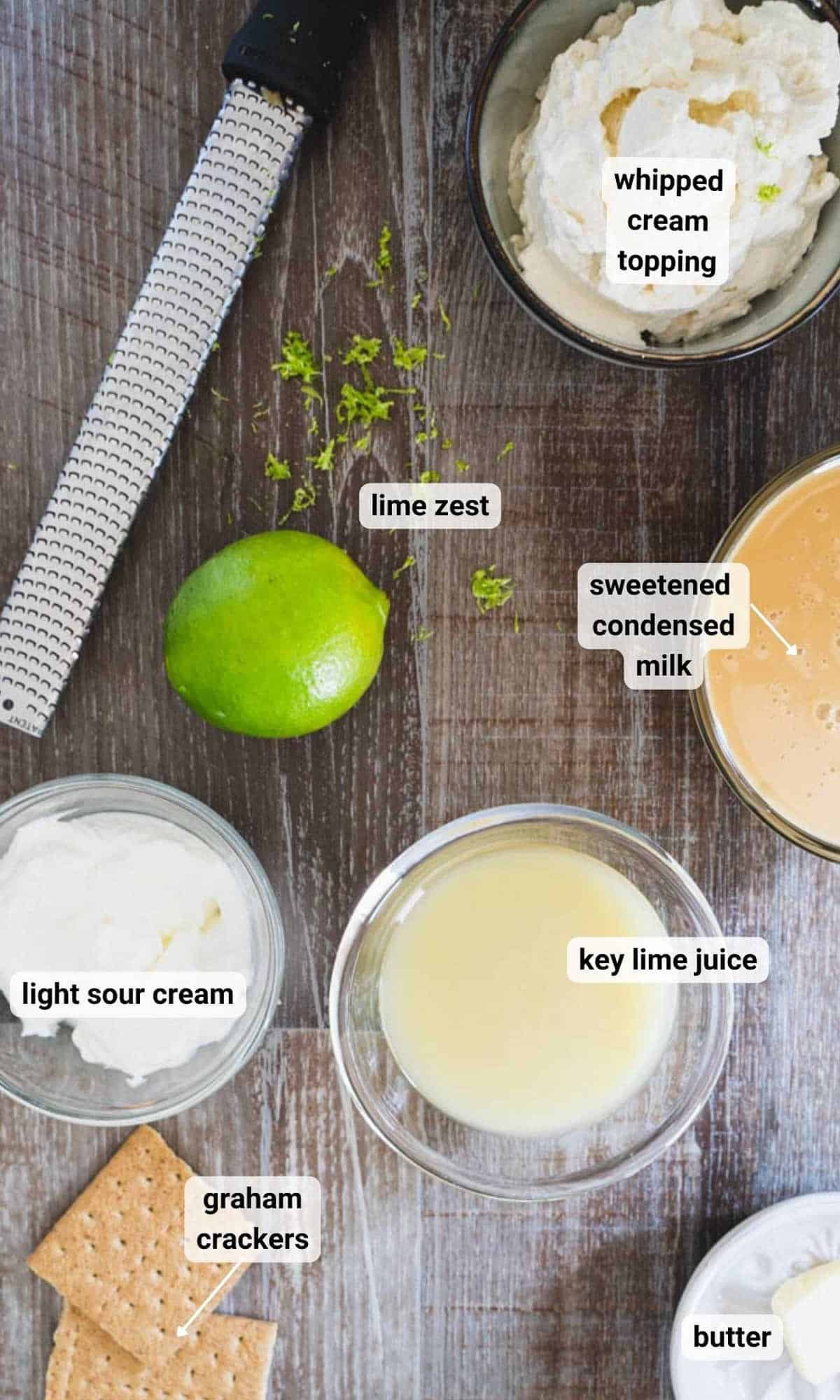 key lime dessert cups ingredients in bowls on a wooden table