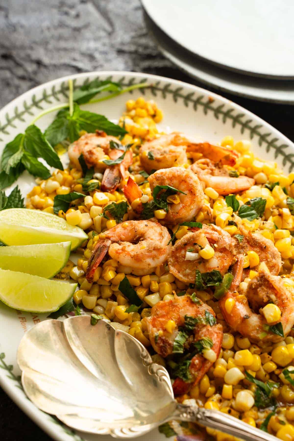 shrimp and corn on a serving platter with lime slices