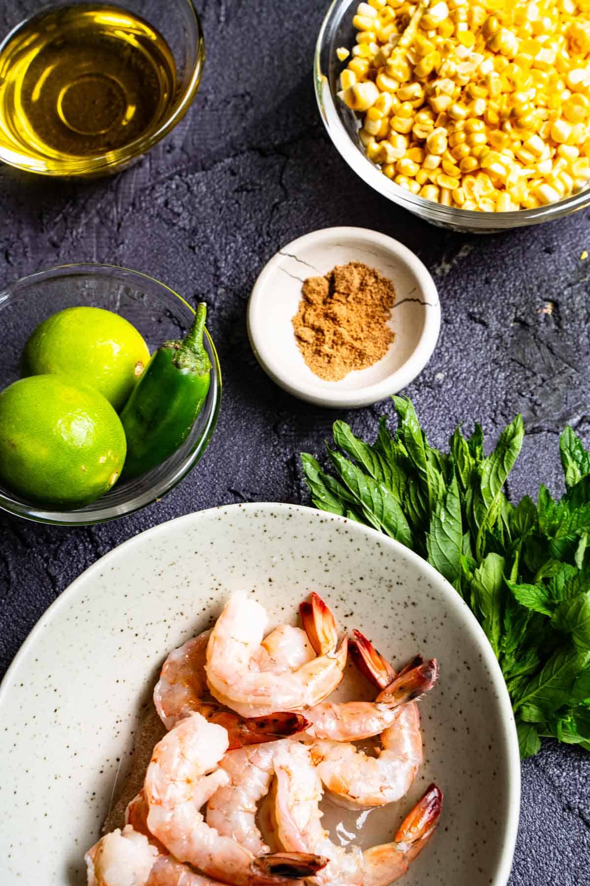 shrimp and corn weeknight dinner for two ingredients on a dark table