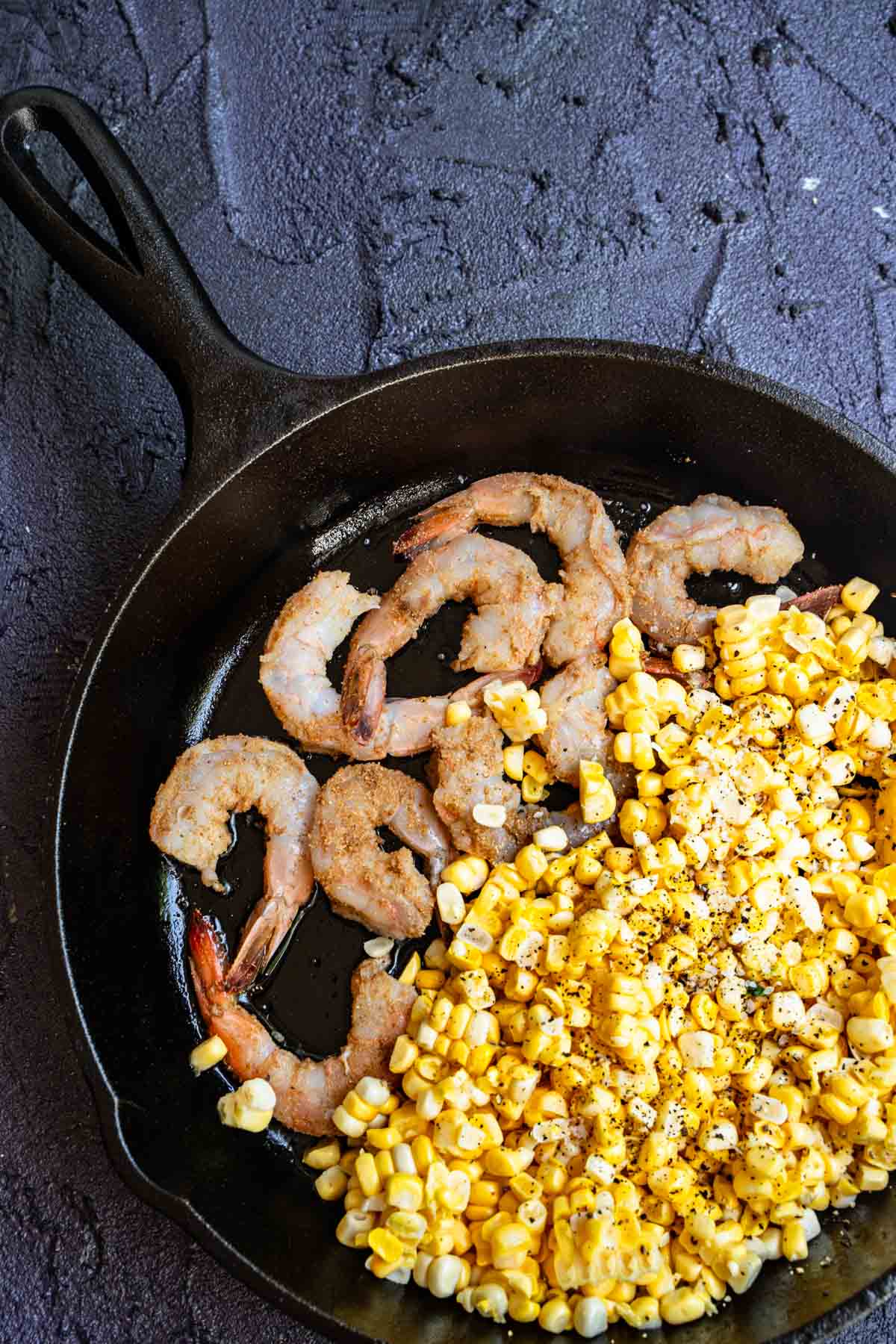 shrimp in an even layer on one side of the pan and corn on the other side.