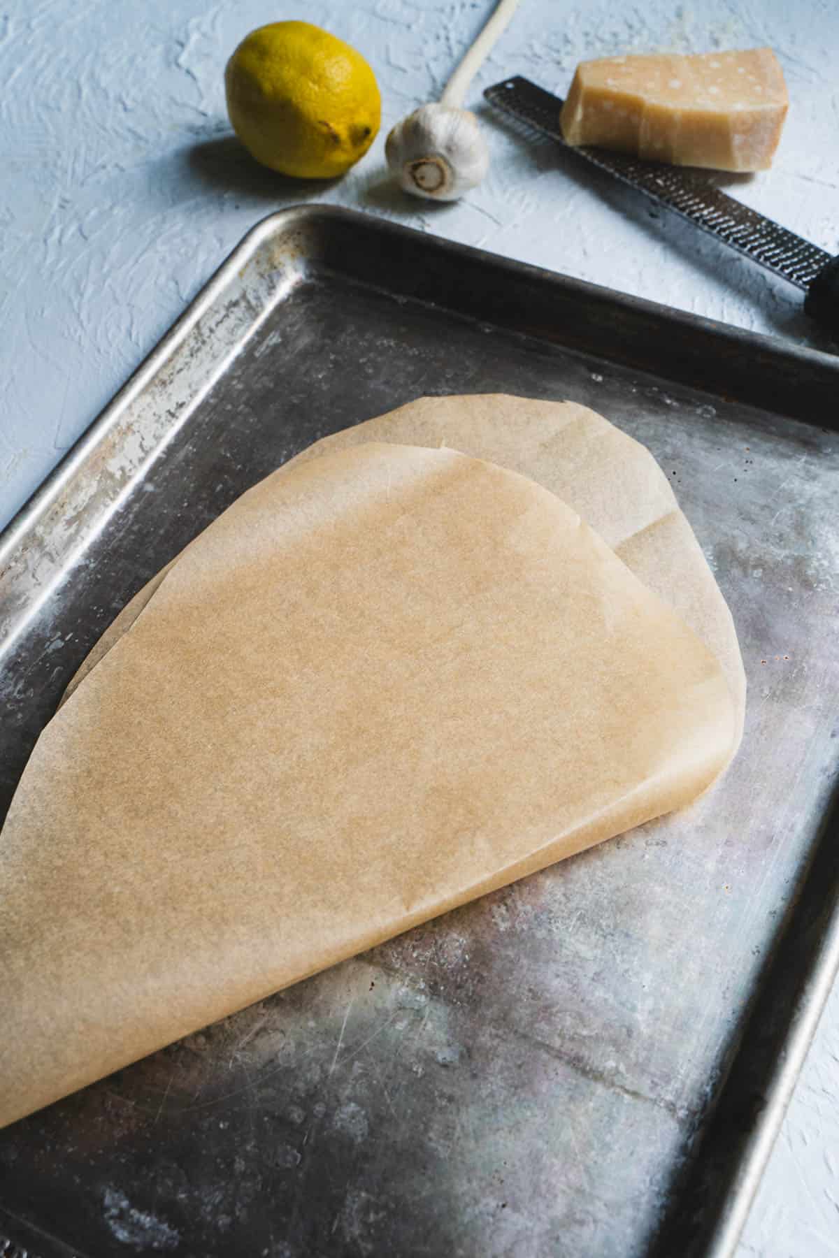 parchment paper on a baking sheet folded in half and cut into a half-hear shape.