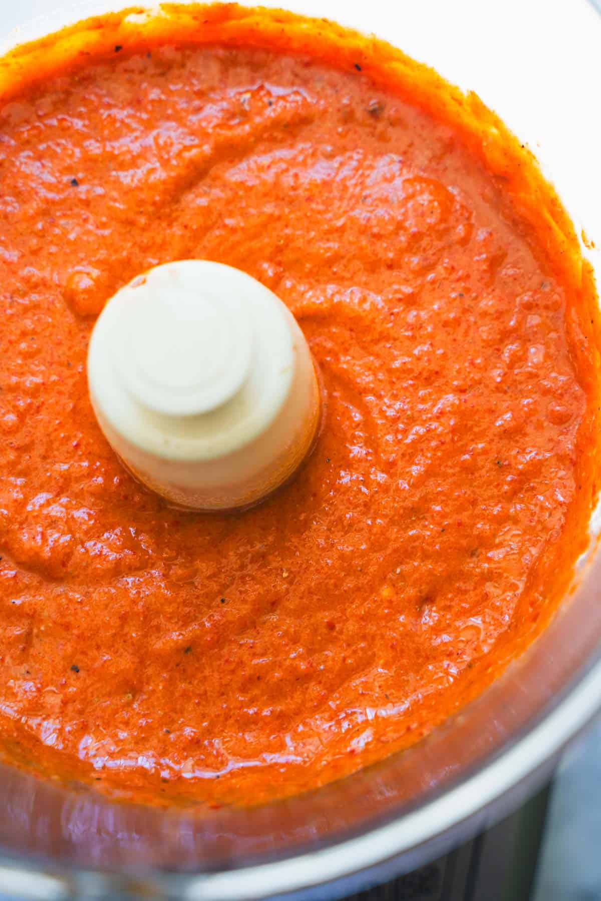 Ajvar pureed in a bowl of a food processor