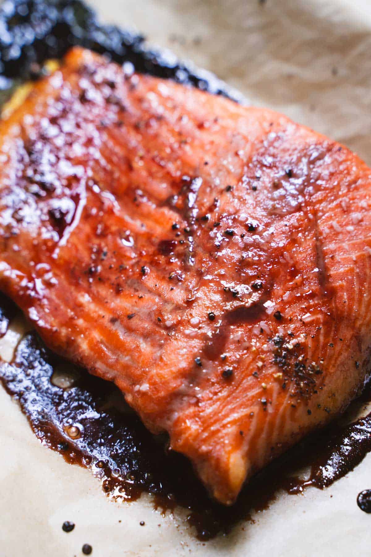 Baked salmon with cherry glaze on parchment paper