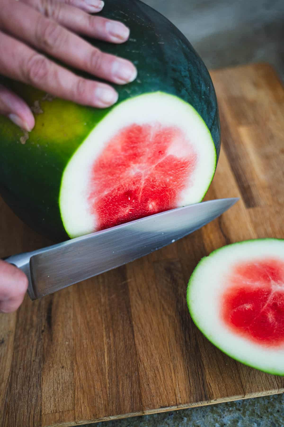 chef's knife cutting end off watermelon