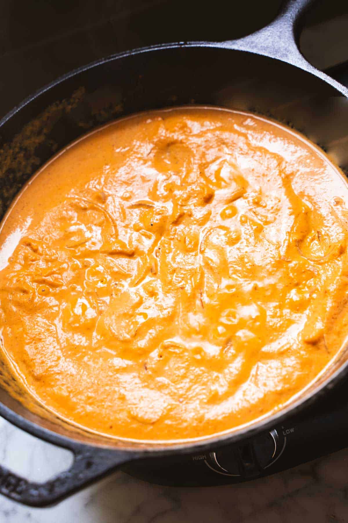 Pumpkin sauce for pasta in a cast iron skillet simmering
