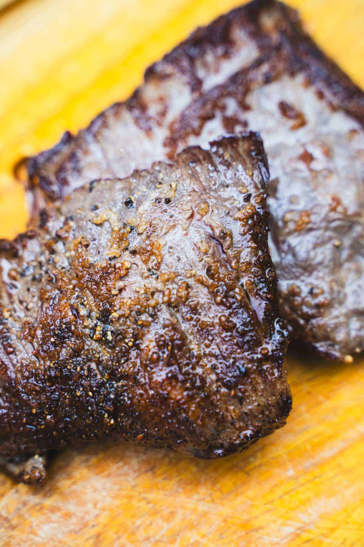 flank steak seared on a cutting board.