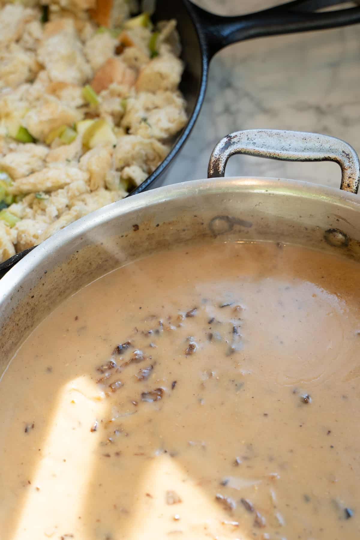 homemade gravy in a skillet ready sitting on a counter.