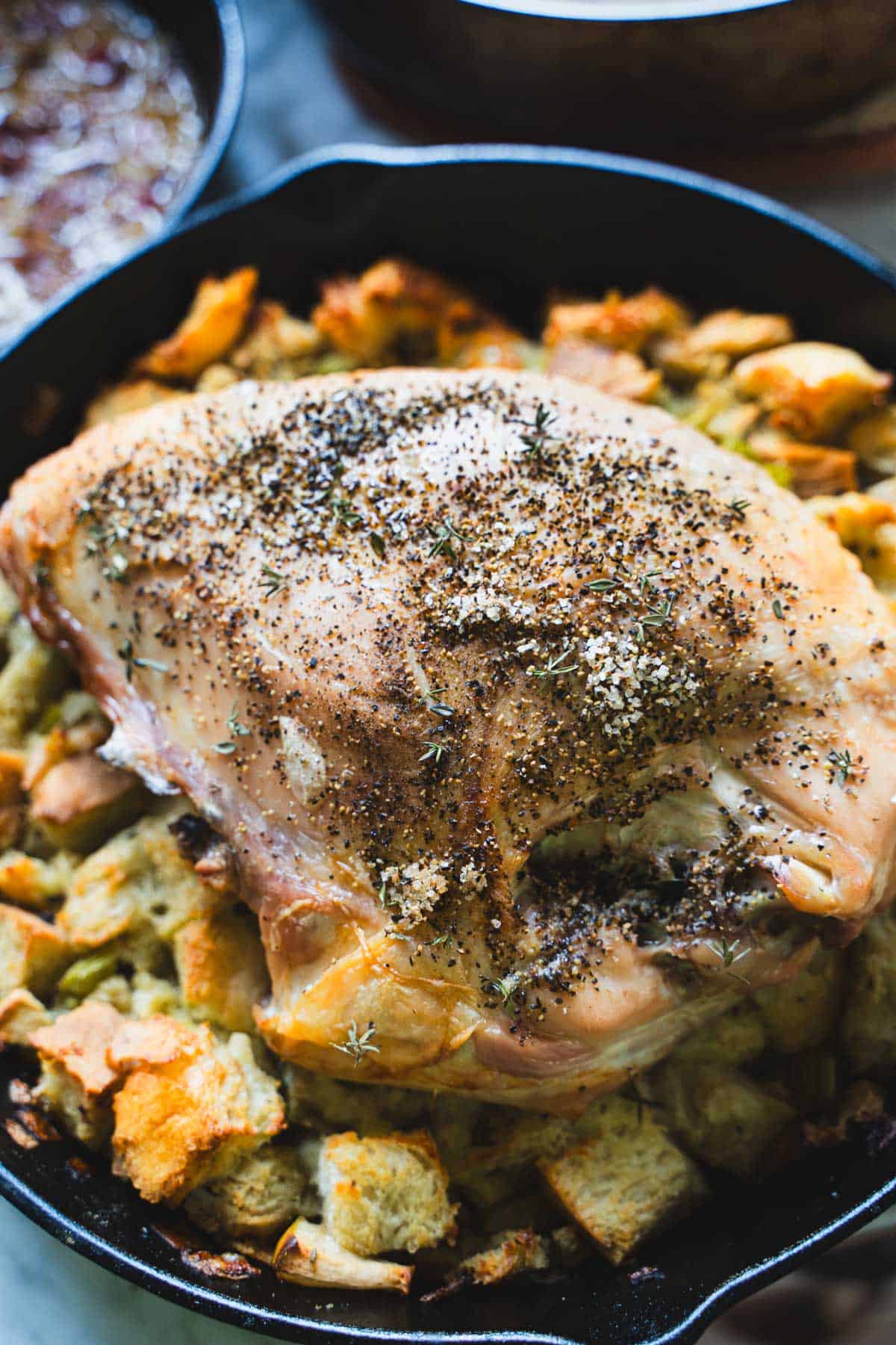 Roasted turkey breast on top of stuffing in one pan.