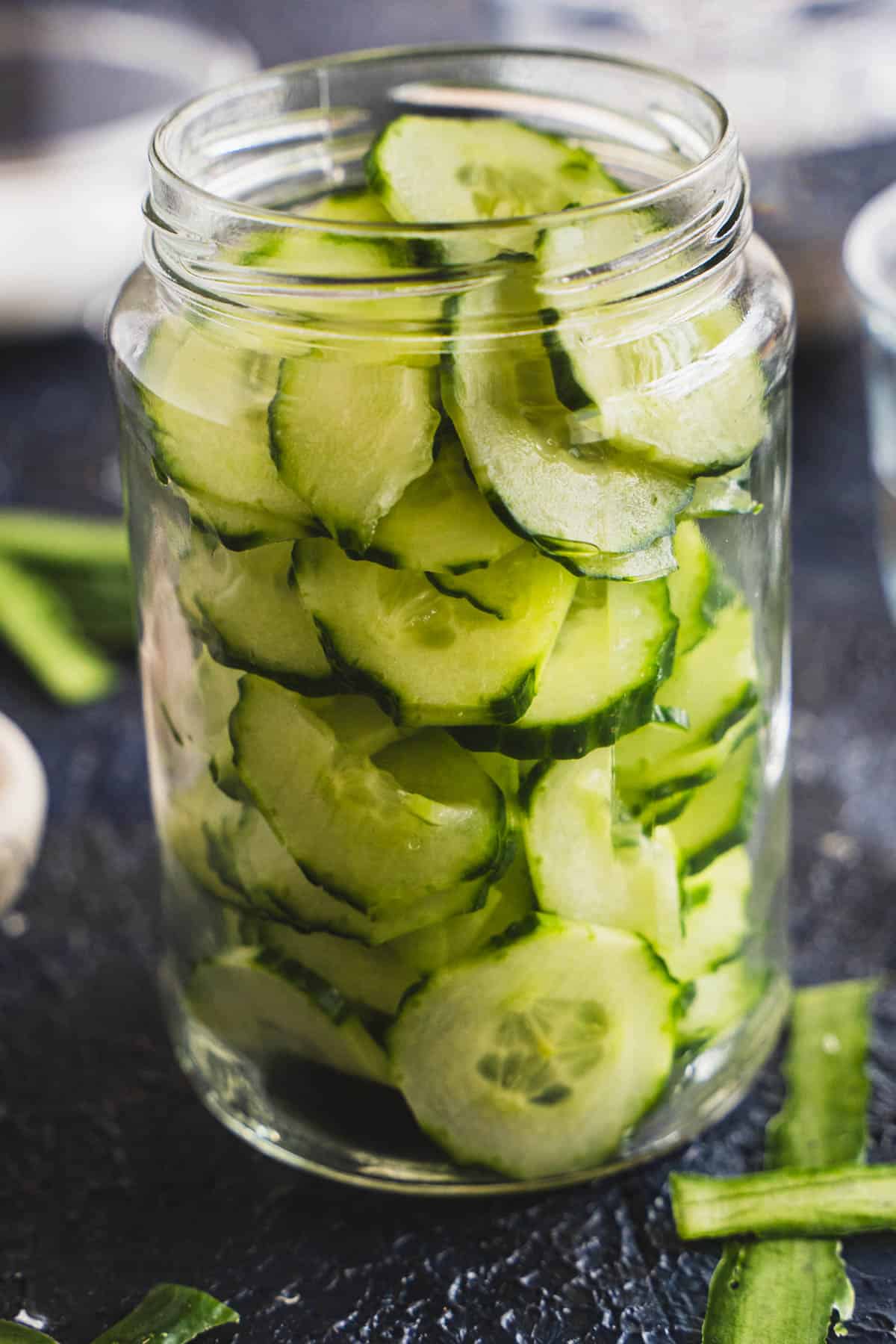 Easy swedish quick pickled cucumbers in a mason jar ready to have brine poured into the jar.