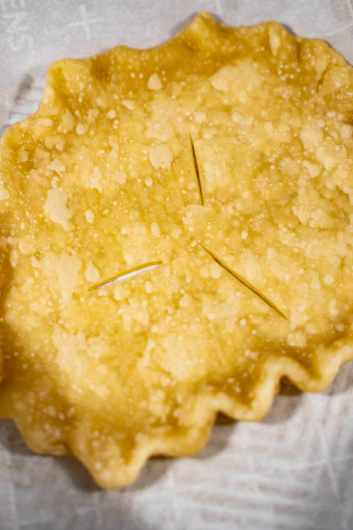 Individual pot pie crust par baked on a baking sheet.

