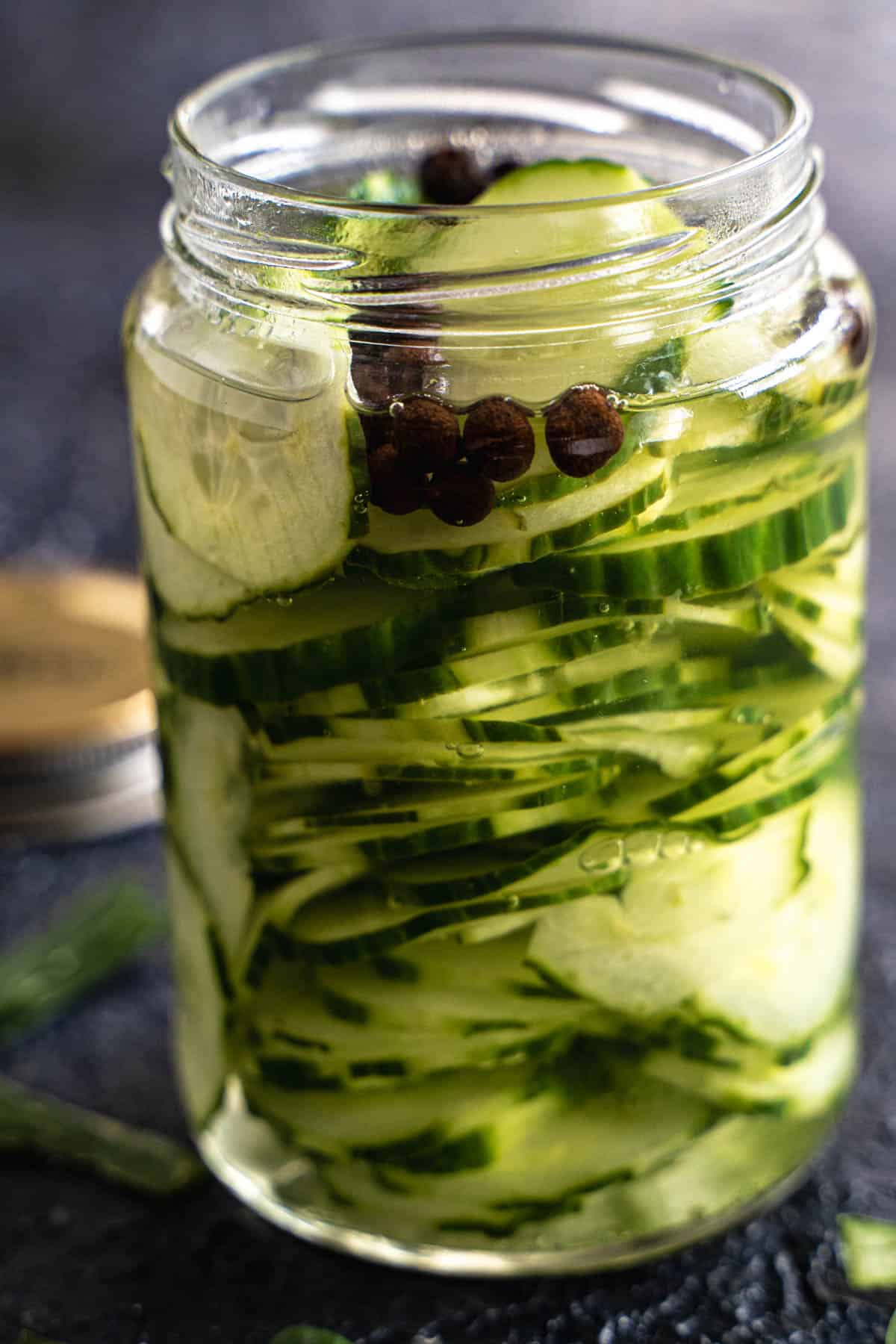 Quick pickled cucumbers in a mason jar.