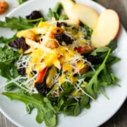 Apple Manchego and Arugula Salad Recipe served on a white salad plate.