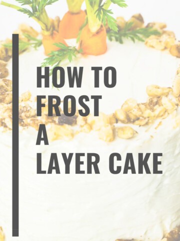 Cream cheese frosted carrot walnut cake with chopped walnuts on edges and fresh carrot tops on top of the small 6-inch 2- layer cake with the words How to Frost a Layer Cake in text.